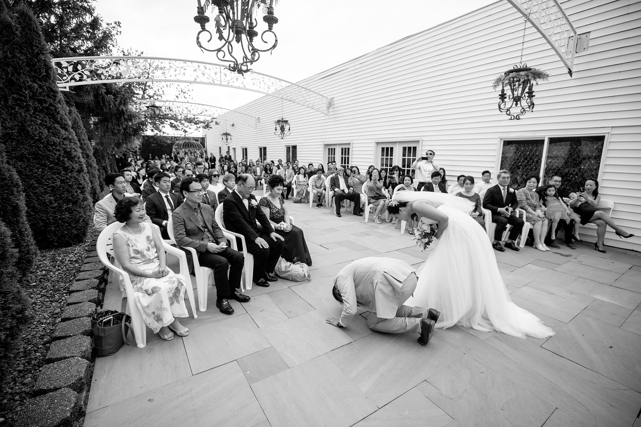 Bride and groom bowing to parents during wedding ceremony at marygold manor in buffalo ny.