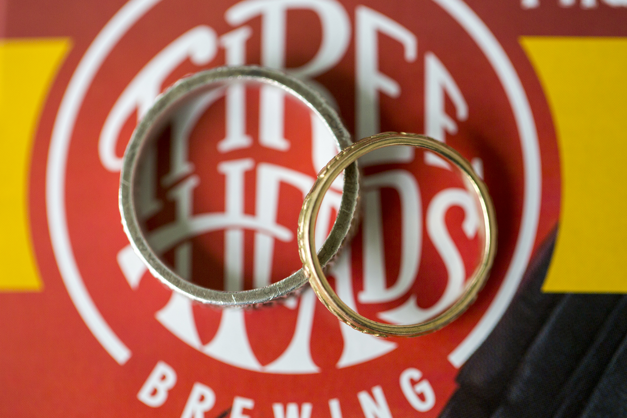 Wedding rings on the three heads brewing logo.